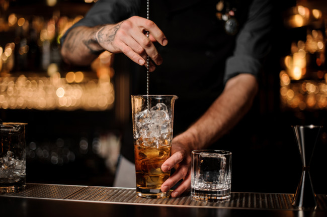 Bartender stirring cocktail - Shutterstock