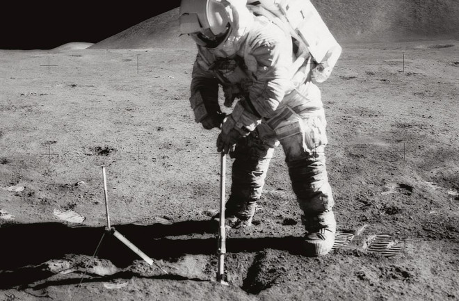 Astronaut James B. Irwin, lunar module pilot, uses a scoop in making a trench in the lunar soil during Apollo 15. (Credit: NASA)