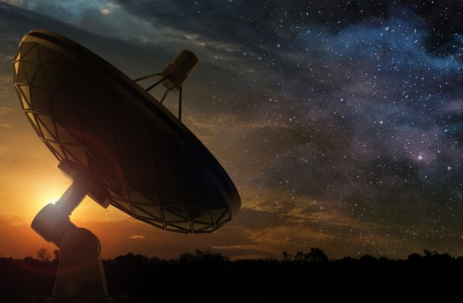 Radio Telescope with Rising Sun and Starry Sky - Shutterstock