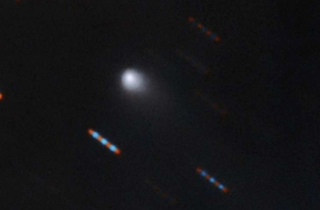The Gemini Observatory in Hawaii caught this first-ever color image of the interstellar comet Borisov and its faint tail. (Credit:Composite image by Travis Rector. Credit: Gemini Observatory/NSF/AURA)