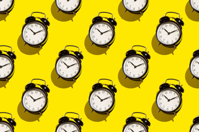 Alarm clocks on yellow background