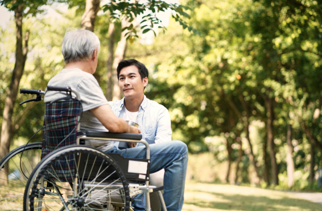 Young man sitting outside with Alzheimer's family member