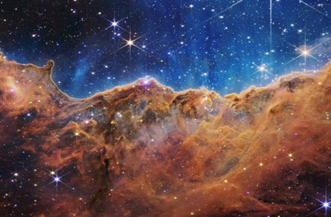 The Cosmic Cliffs shows the star-forming Carina Nebula in exquisite detail, revealing newborn stars and their dynamic influence on their environment.