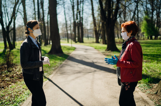 mask women chatting park - shutterstock