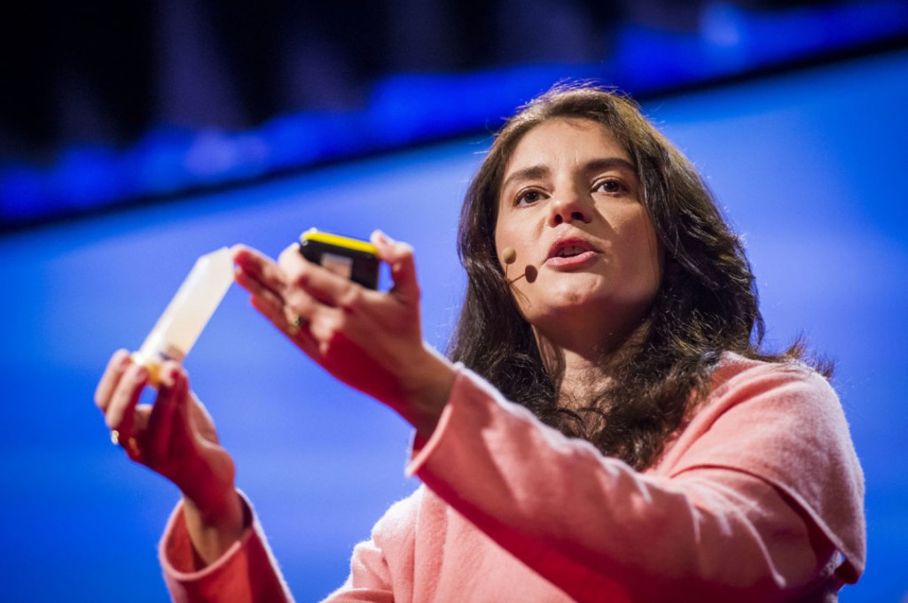 Neuroscientist Suzana Herculano-Houzel holds up a tube that contains a liquid suspension of all the cell nuclei that once made up a mouse brain. (Credit: James Duncan Davidson/Flickr)
