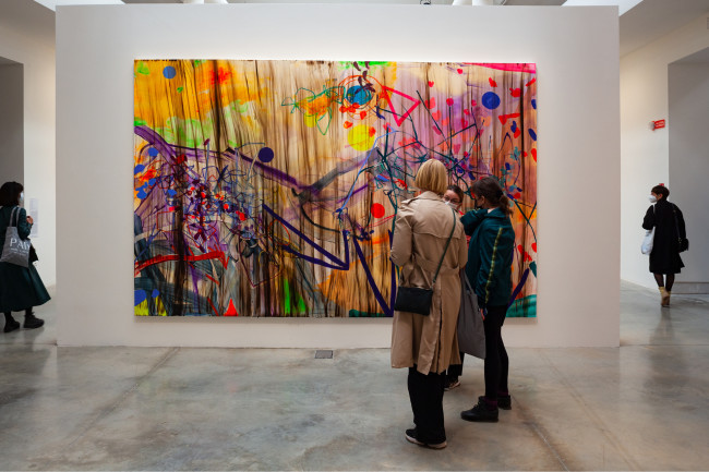 Visitors admiring the beauty of a painting at the 59th Venice Biennale
