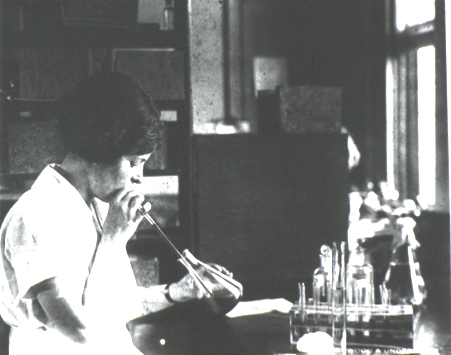 A woman mouth pipetting to select specimens of ectoparasites. Source: National Library of Medicine