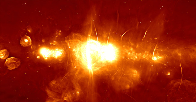 The center of our galaxy, imaged by the MeerKAT radio telescope, is full of mystery. A black hole lurks at the center. Nobody knows what causes the filaments. (Credit: SARAO)