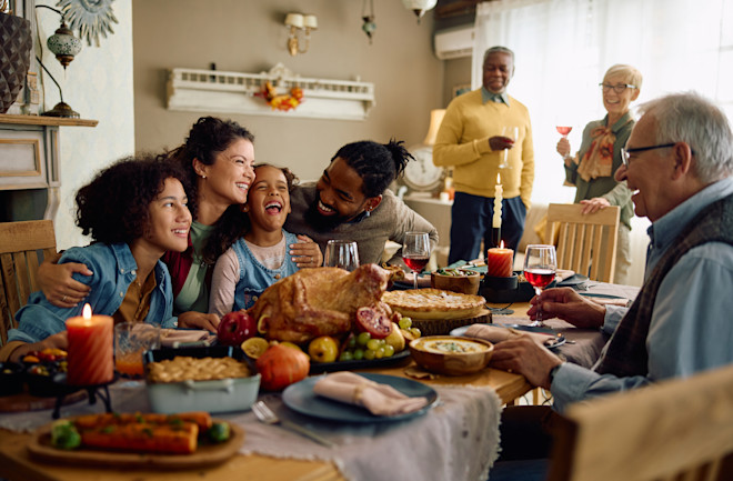 Family gathering around a table for thanksgiving