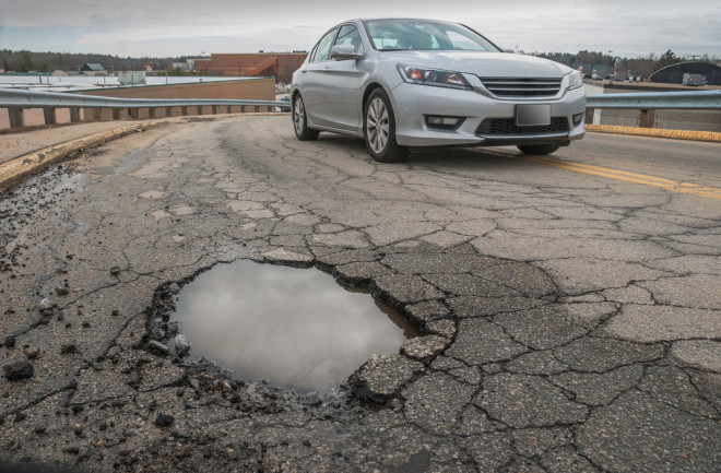 Potholes in the road - shutterstock