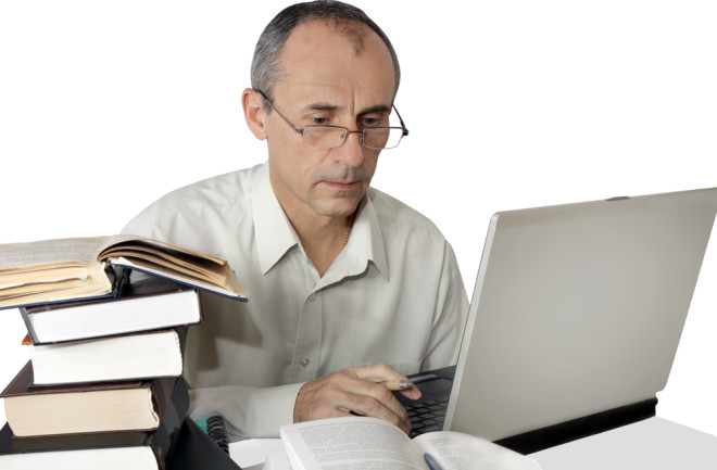 Man Reading Books Computer Peer Review - Shutterstock