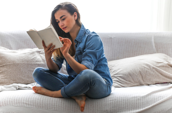 woman reading book - shutterstock