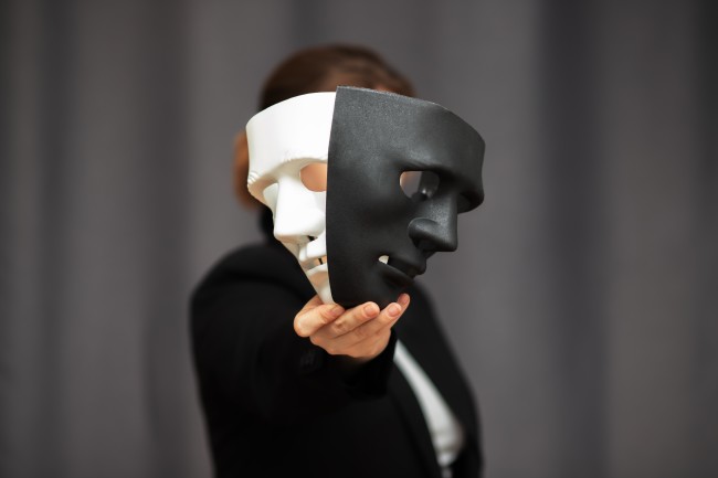 Theatre actor holding drama and comedy mask 