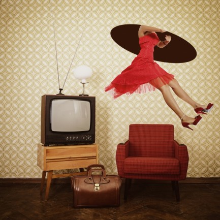 Woman wearing a red dress in a vintage living room traveling through time hole in celing