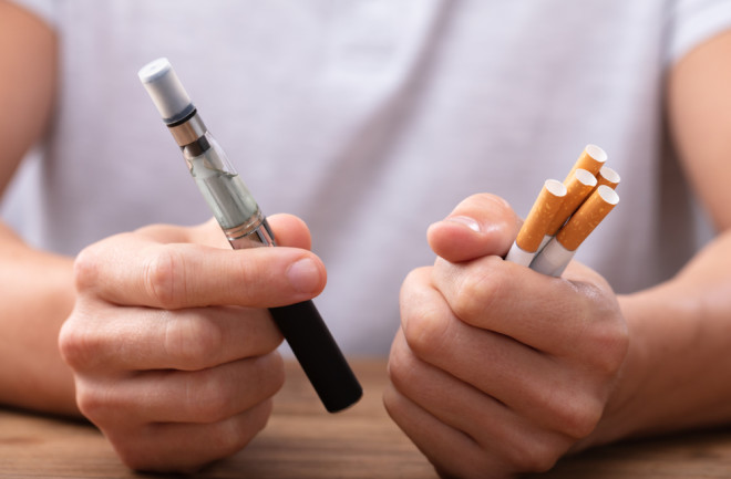 holding cigarettes or vape health decision  - shutterstock