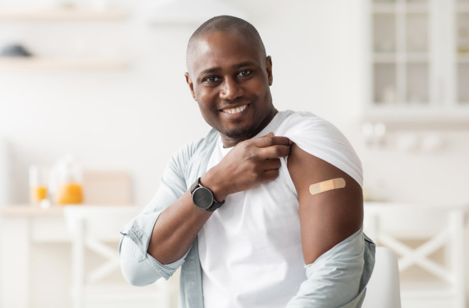 vaccine band aid smiling man -m shutterstock 1942433743