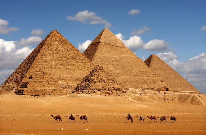 pyramids in eqypt with camels - shutterstock