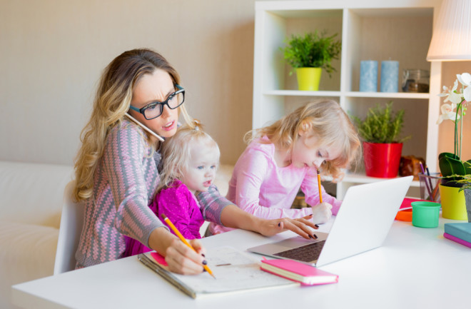 mom working from home and balancing childcare - shutterstock 1070125520