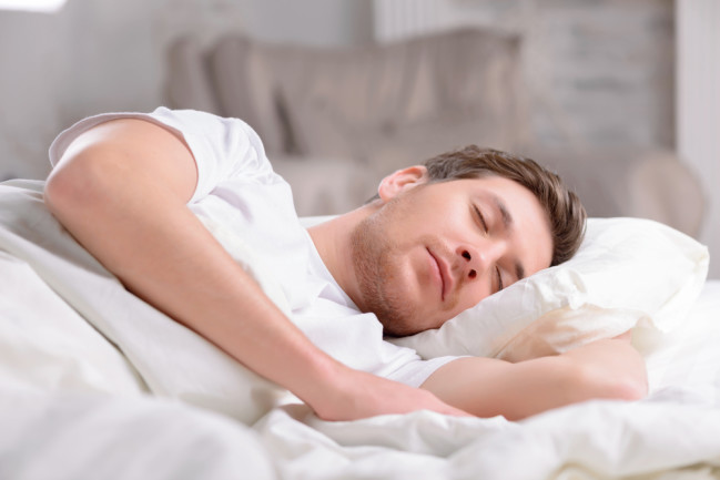 Man lying in bed sleeping 