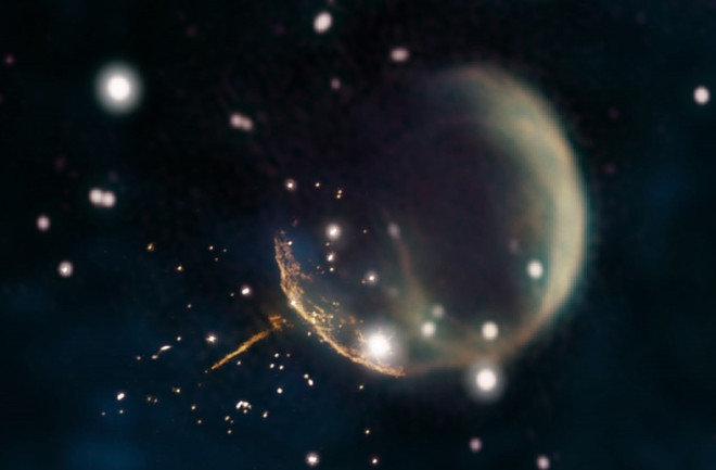 PSR J0002 is clearly visible with its bright radio tail pointing back toward the explosion that created it, the supernova remnant CTB 1. (Credit: Credits: Composite by Jayanne English, University of Manitoba, using data from NRAO/F. Schinzel et al., DRAO/Canadian Galactic Plane Survey and NASA/IRAS)