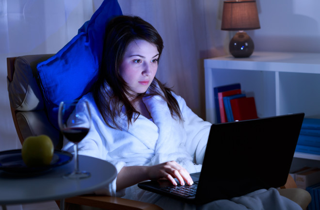 A young woman is spending time in front of her laptop.
