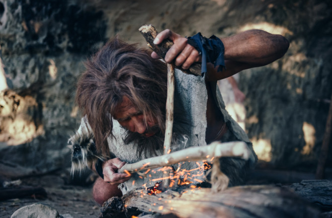 caveman starting a fire