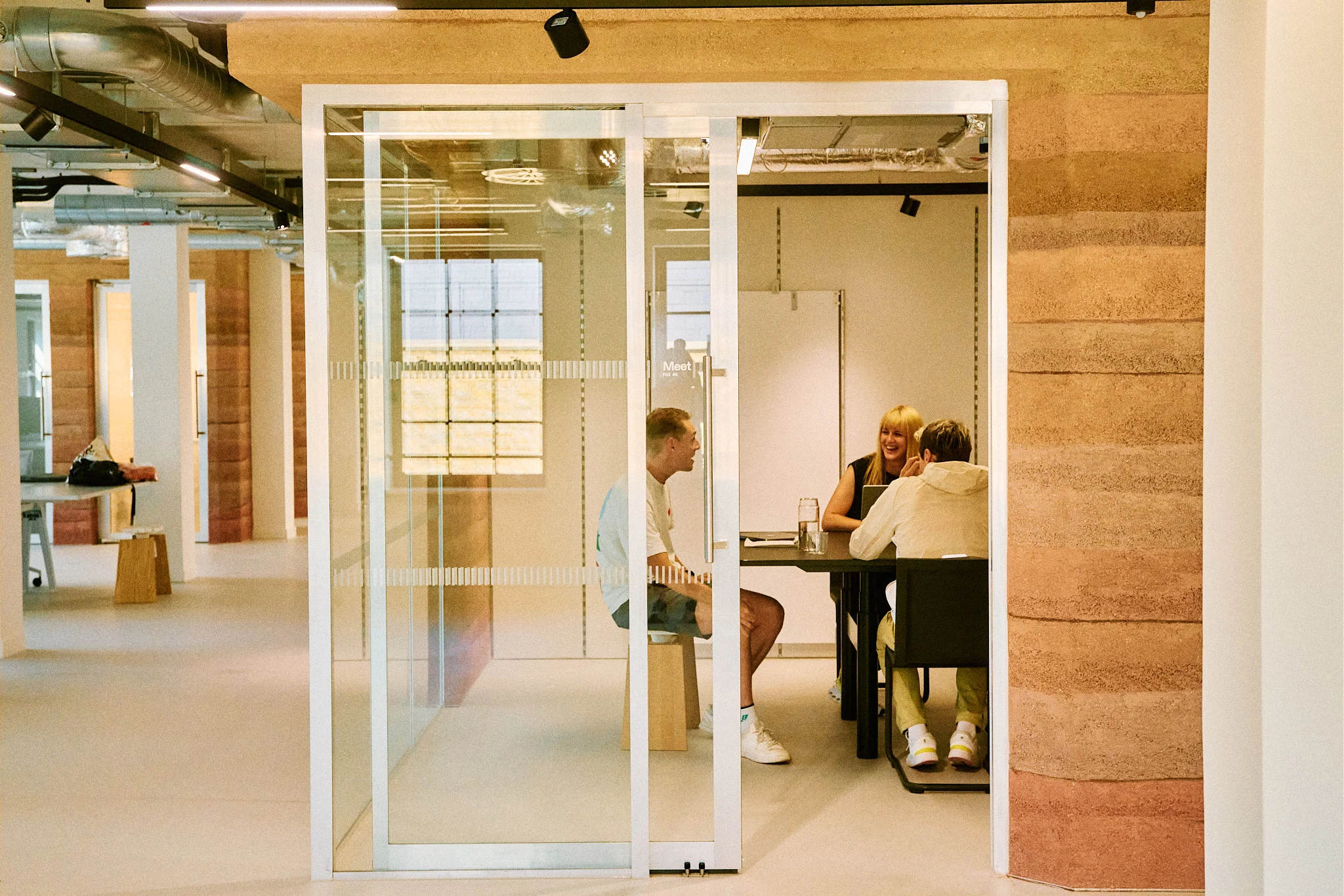 Three people at a meeting room