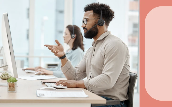 Photograph of two people using customer feedback management to help customers.