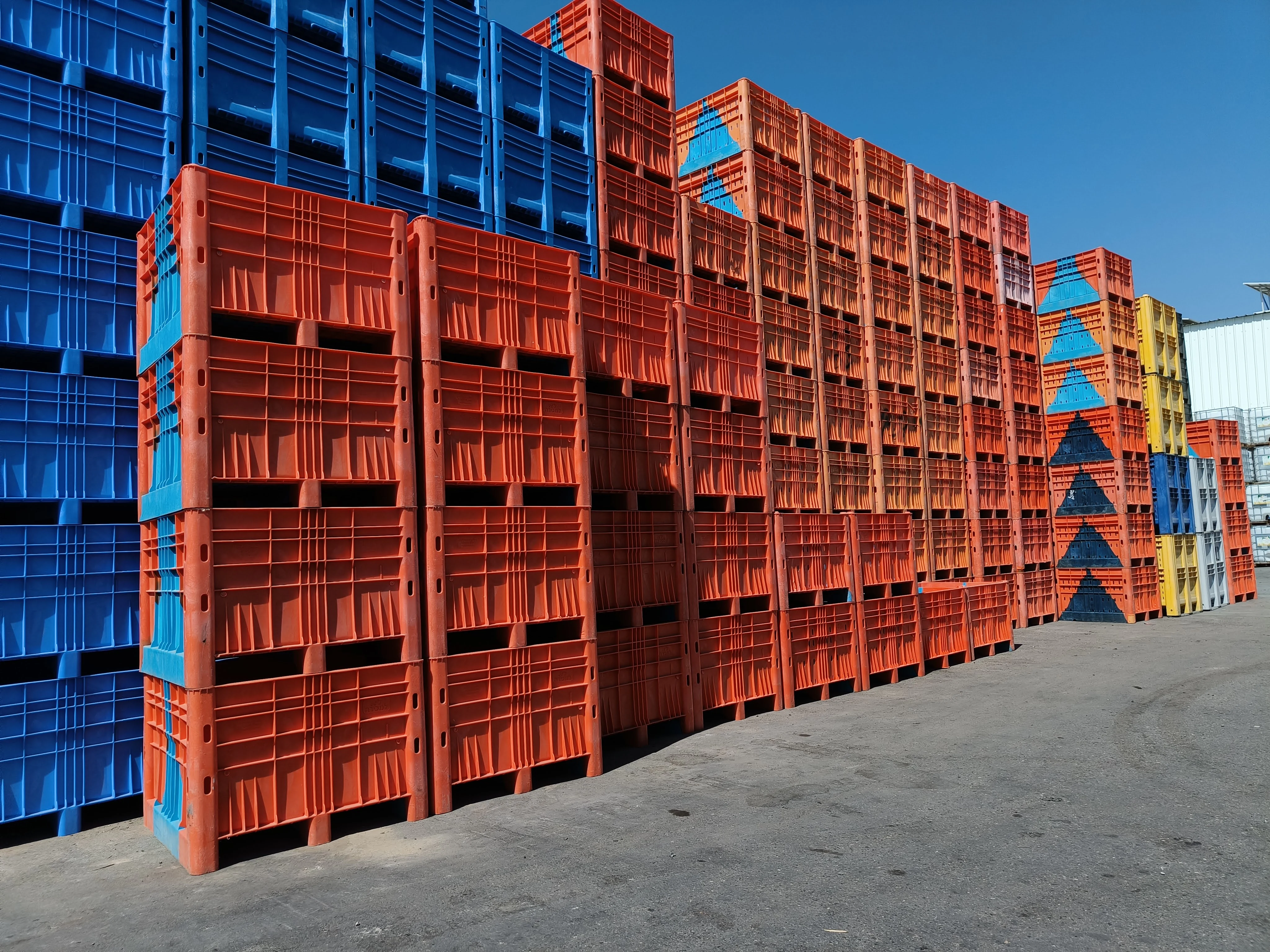 Walls of crates in the supplier's yard — where the boxes come from before they come home.