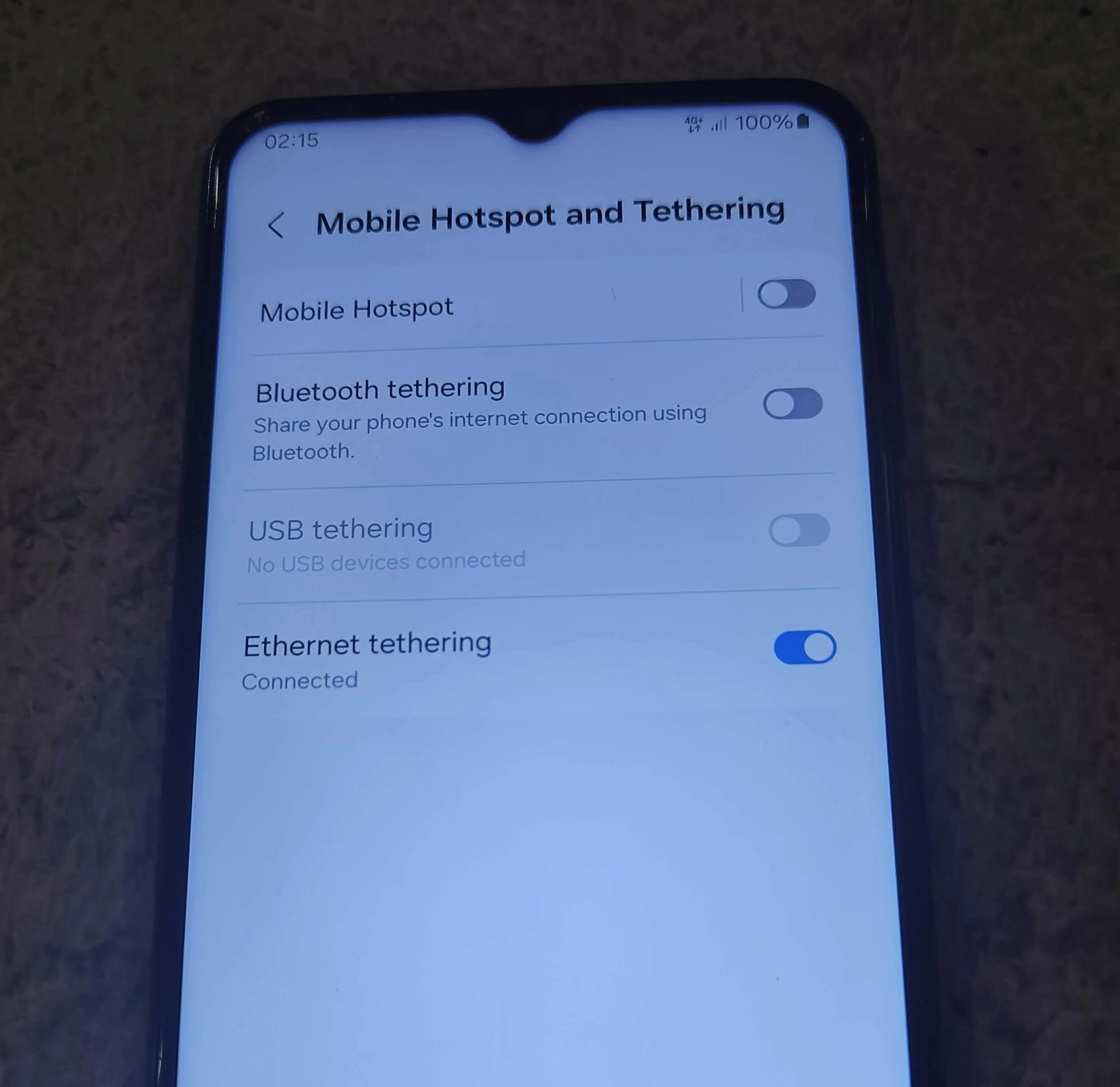 Screenshot of Android phone showing Mobile Hotspot and Tethering settings with Ethernet tethering enabled