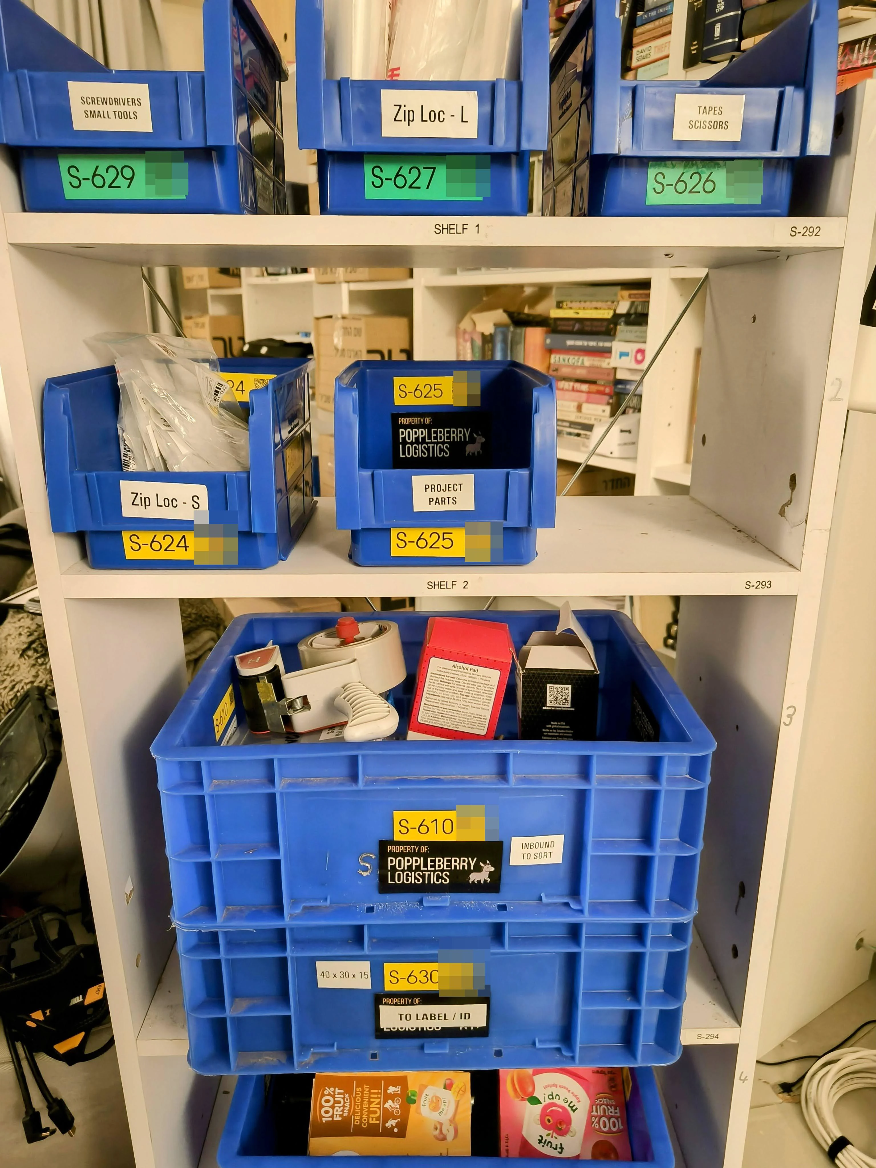 Shelf bay with every bin and box carrying a location code — S-624, S-625, S-610, S-630.