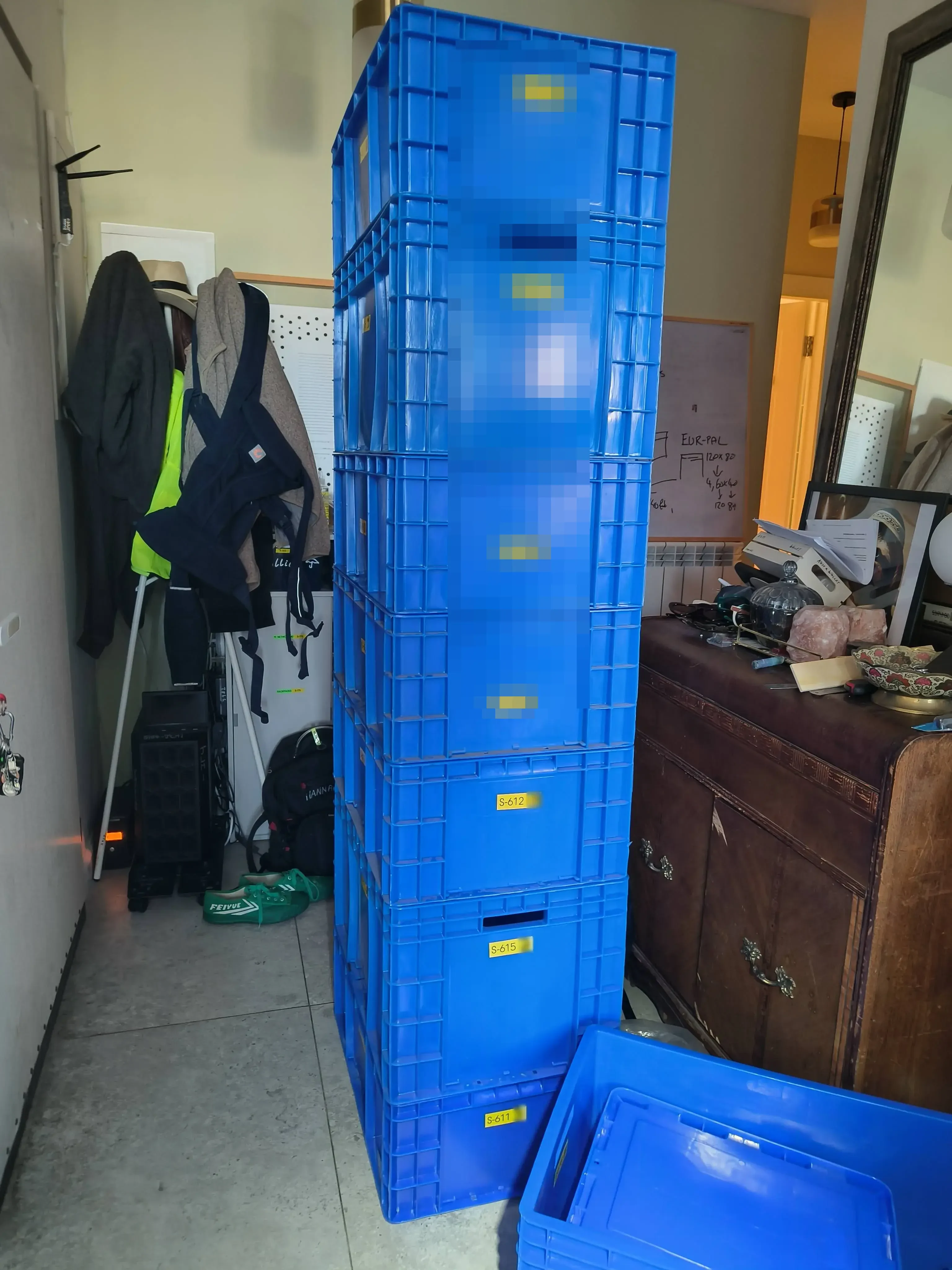 Interlocked Euroboxes stacked in an apartment hallway