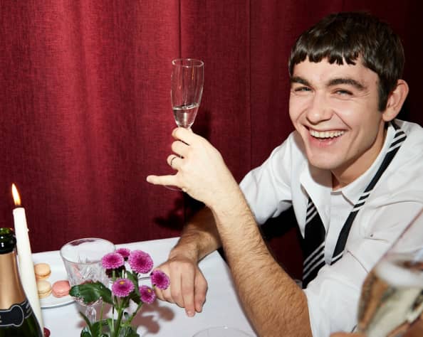 Attendee cheering at an event with a glass of champagne