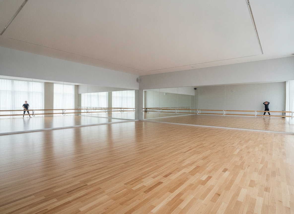 A modern dance studio with mirrors, fully prepared for a dance class.
