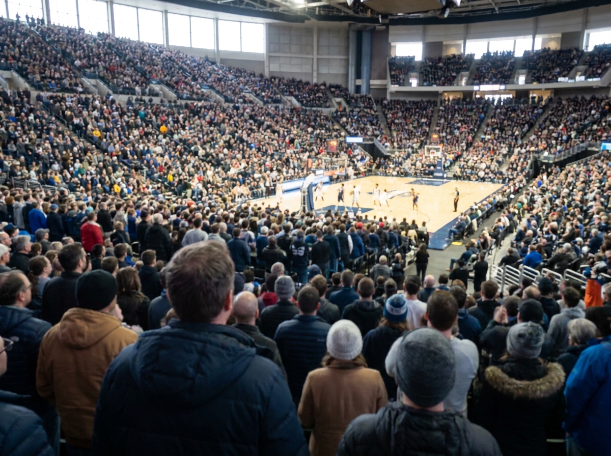 A large crowd of fans watching a basketball tournament from the stands.