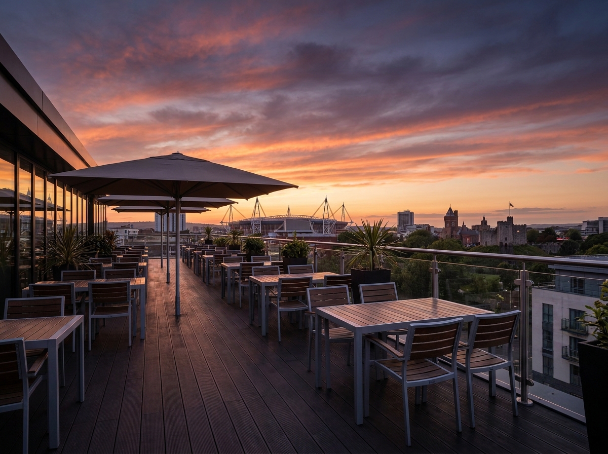 The Cardiff city skyline viewed from a modern event space at sunset.