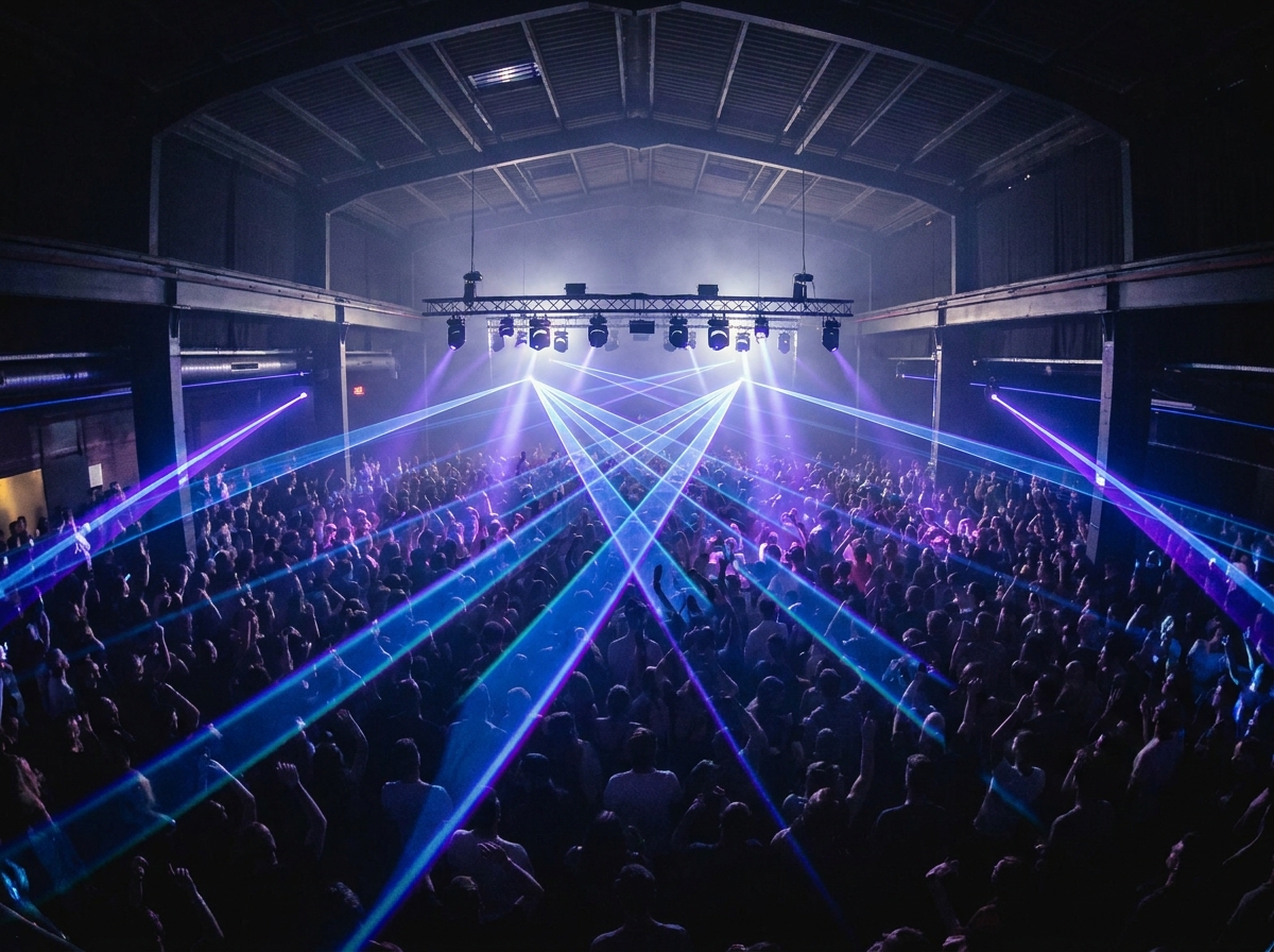 An aerial view of a crowded dance floor at a DJ event.