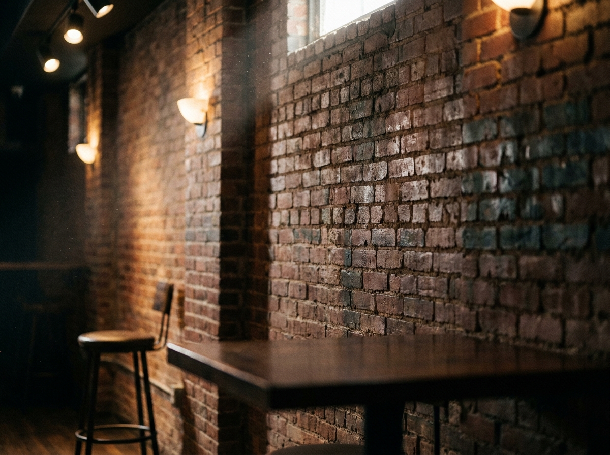 Textured brick wall of a comedy club, representing an intimate venue.