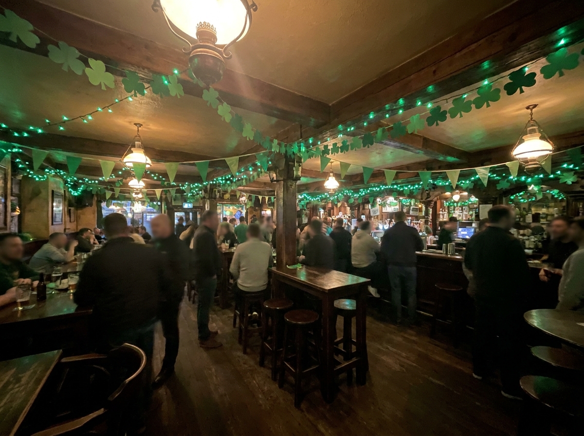 Interior of a pub decorated with green lights and shamrocks for a St. Patrick's Day party.