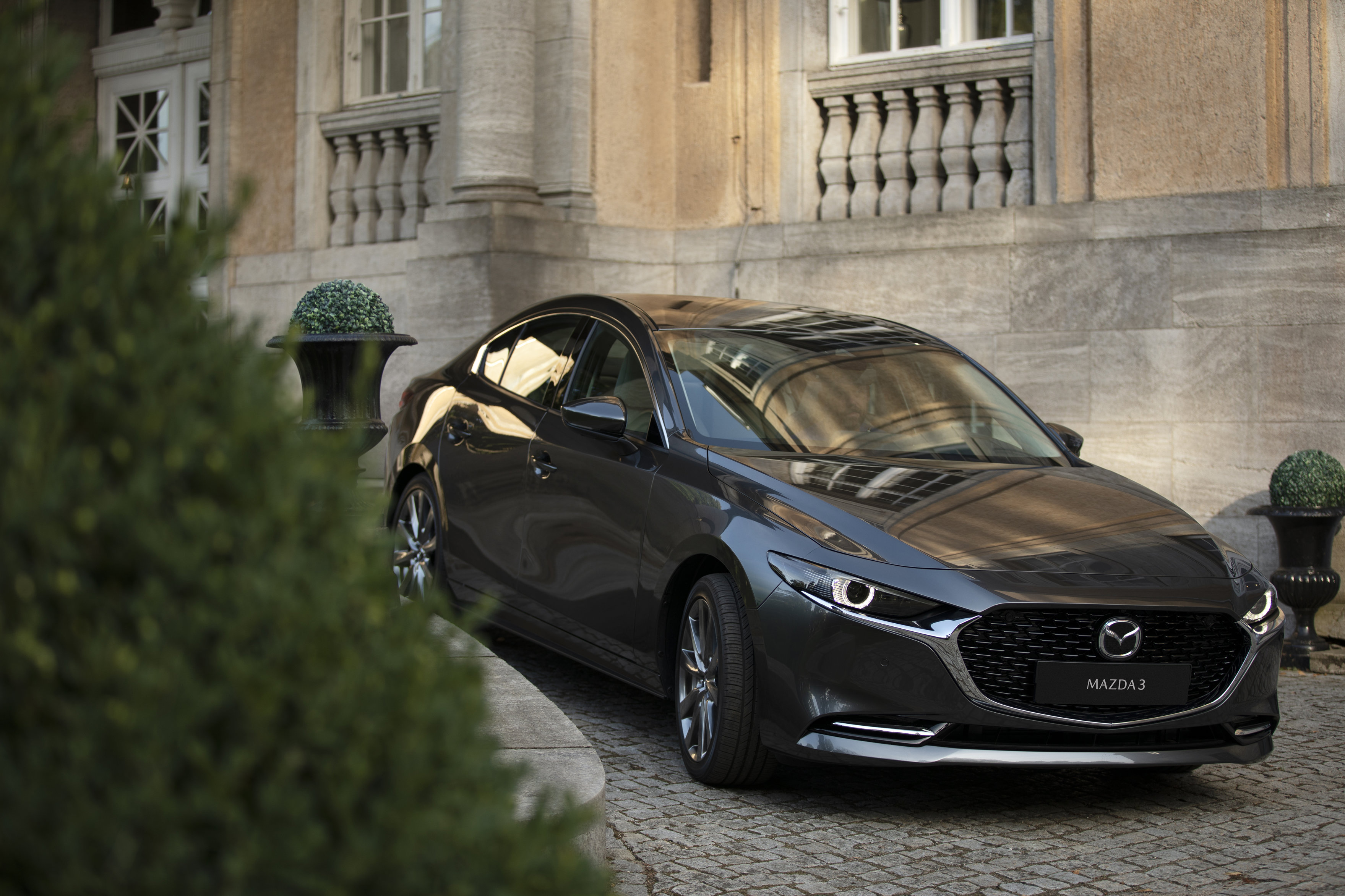 Source: https://de.mazda-press.com/cars/mazda3/ — press image, editorial use. Body verified visually as sedan (the German portal mislabels this asset "Fastback"; Mazda AT/PT label it "Sedan"). Run: 2026-09-18