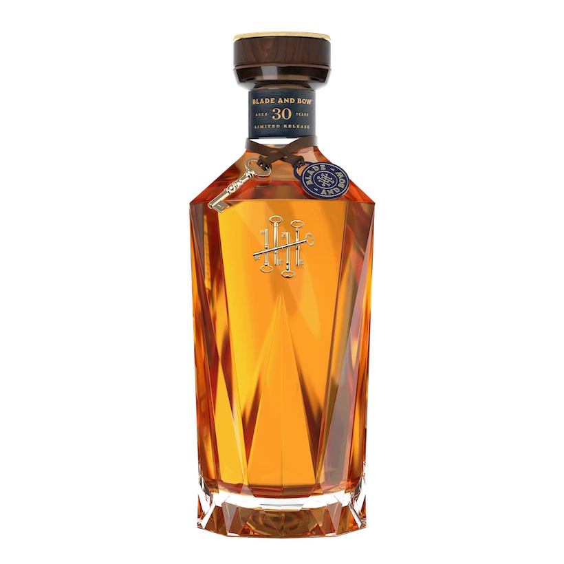 A bottle of Blade and Bow 30-Year-Old Limited Release bourbon. The bottle features a faceted design with amber liquid visible inside.