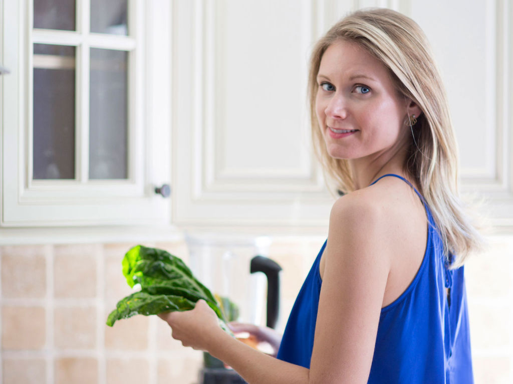 Jolene Hart  in her kitchen holding vegetables