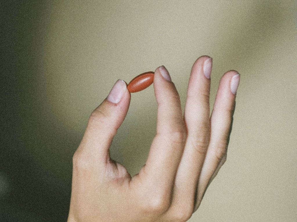 Hand holding a collagen supplement