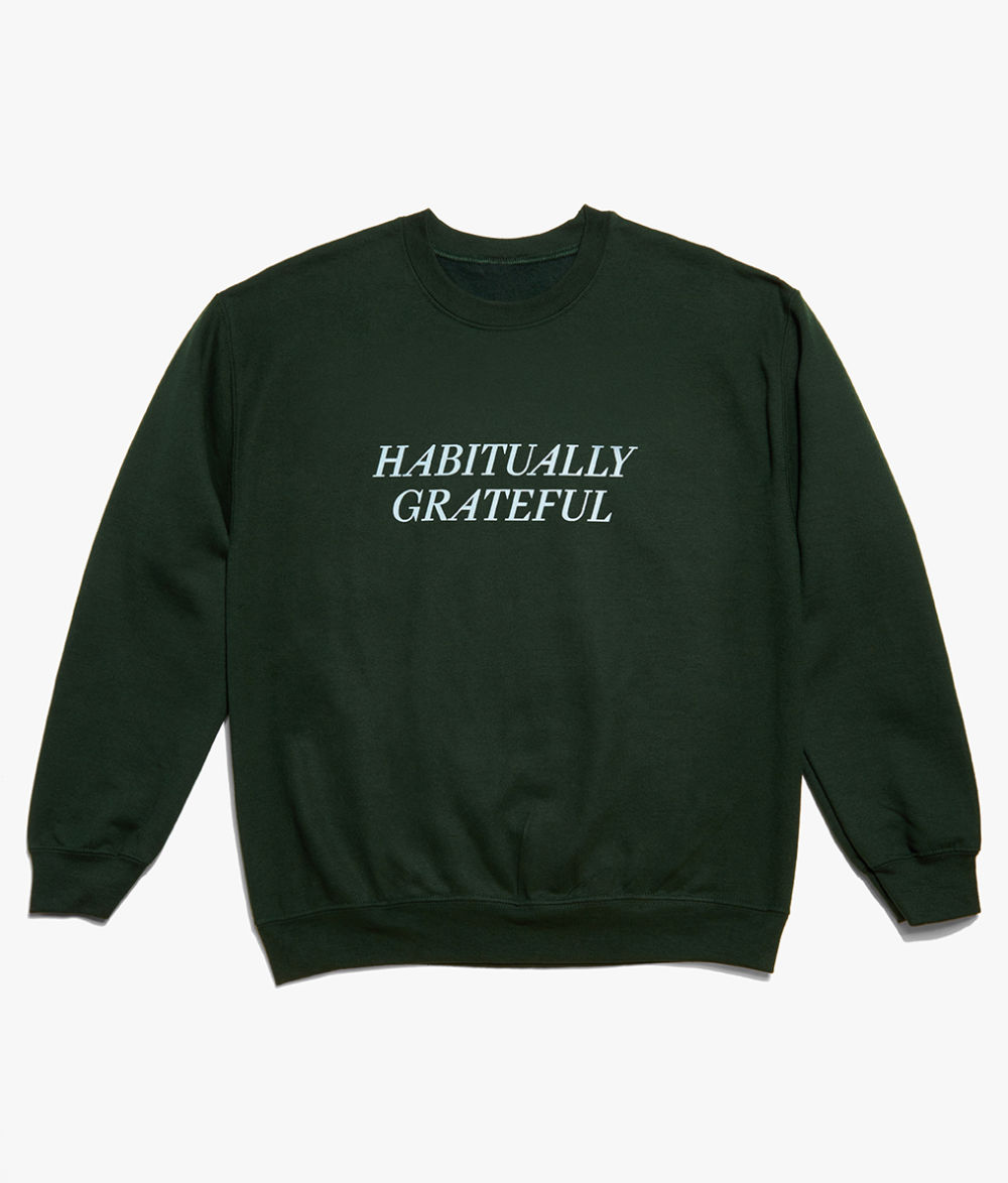 Flat lay of green Habitually Grateful sweatshirt