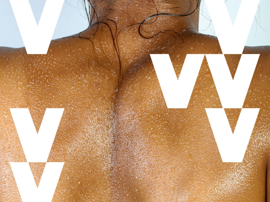 Woman's toned back with water beads on her skin.