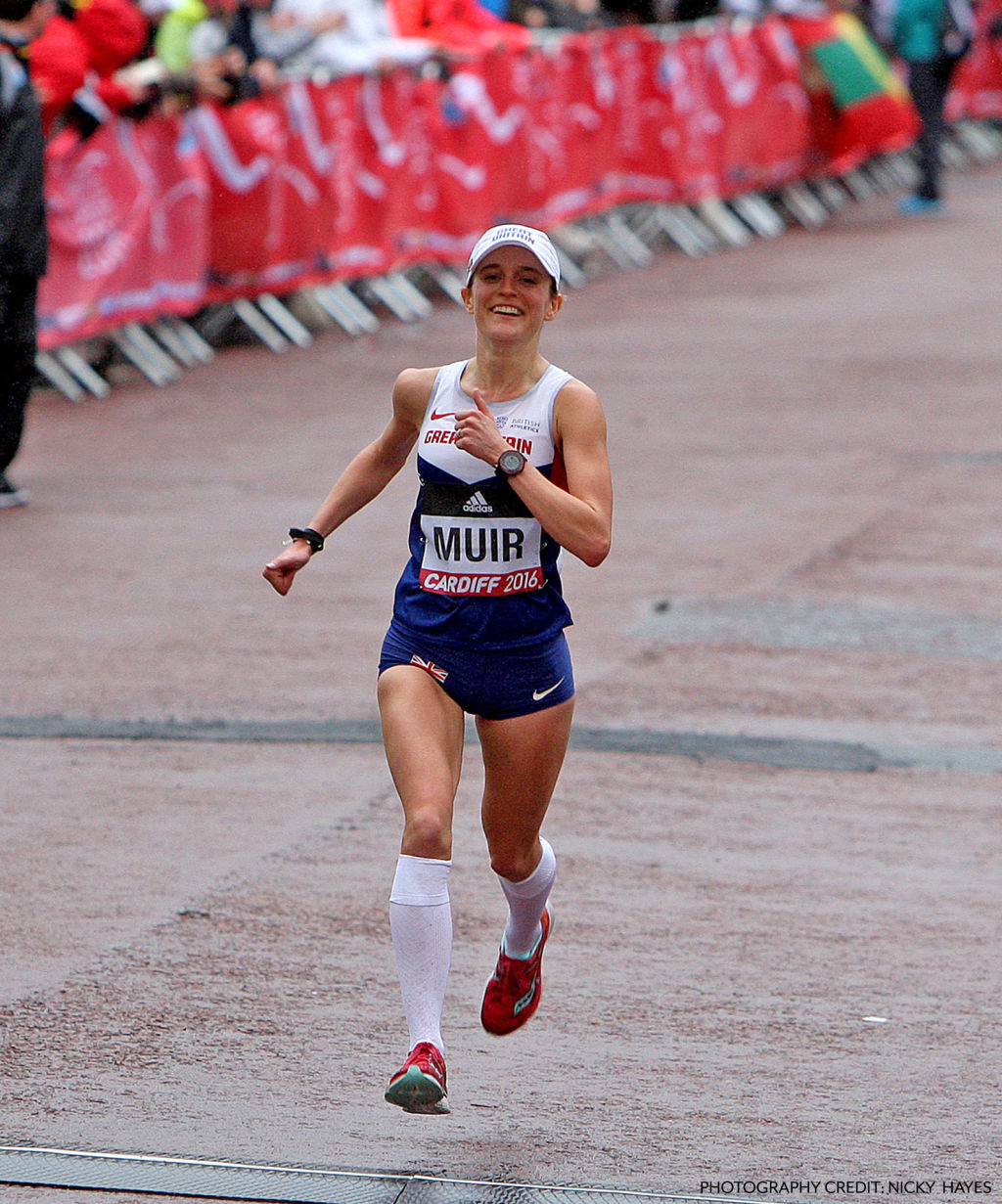 Tina Muir joyfully running in a race with onlookers