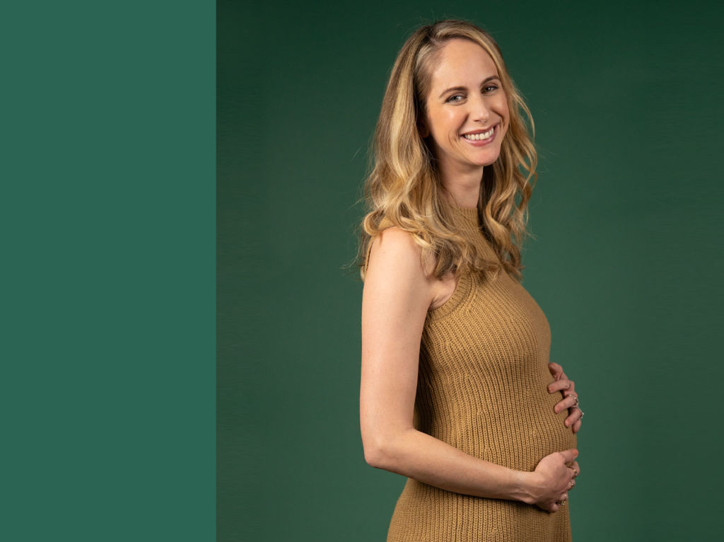 Allie Egan, Veracity Founder smiling and holding her pregnant belly
