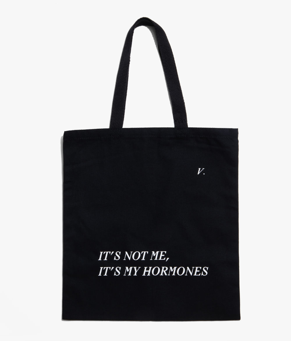 Flat image It's Not Me, It's My Hormones Tote in black with cream lettering