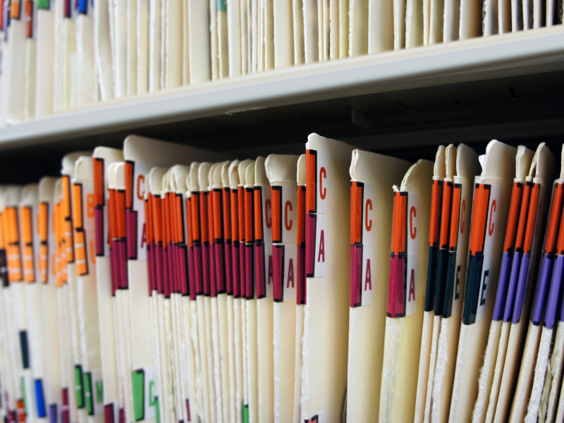 Stacks of Dental Records that have been organized according to best practices