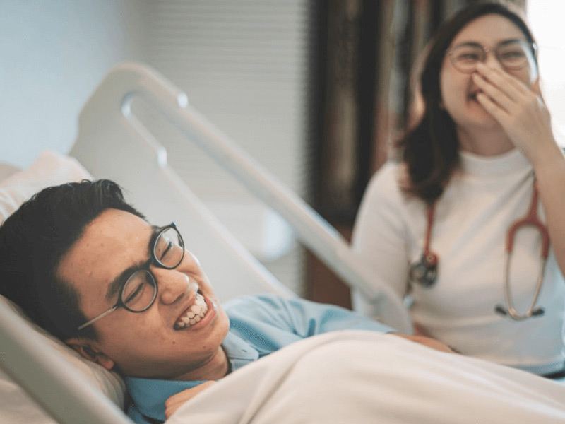 nurse and patient laughing in the hospital